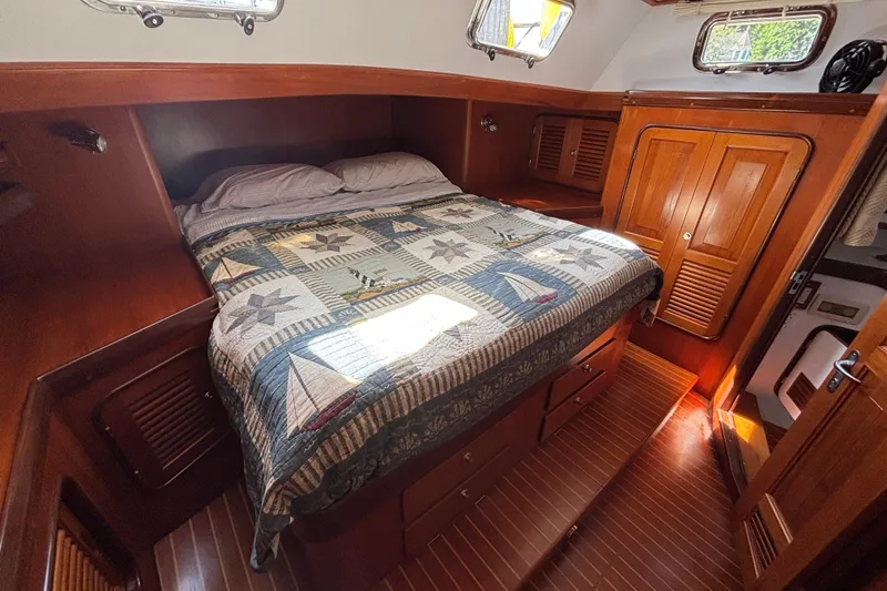Slide: The Image of Cozy cabin interior of 2002 Passport 470 Center Cockpit sailboat with nautical-themed bedding. - 64