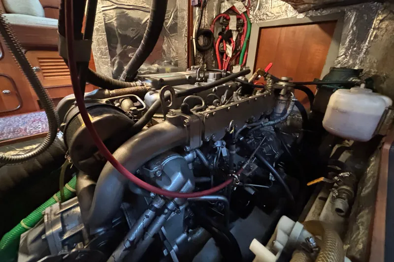 Slide: The Image of Engine room of a 2002 Passport 470 Center Cockpit sailboat, showcasing detailed machinery. - 79