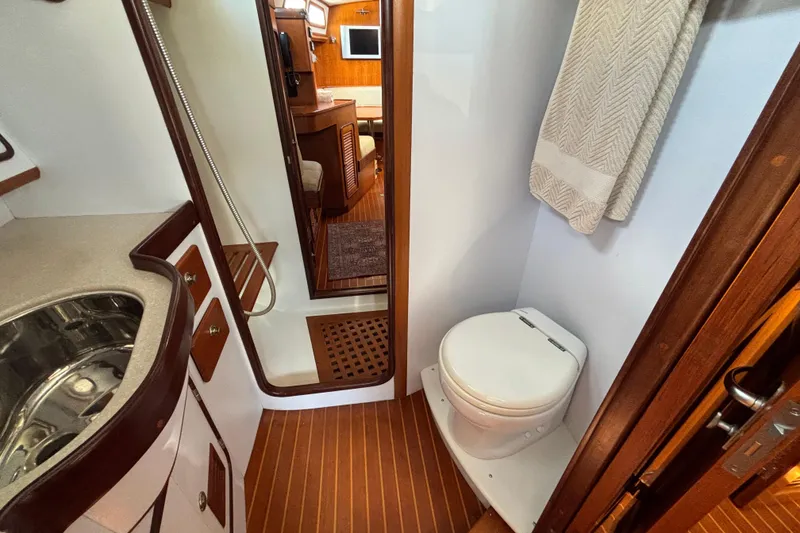 Slide: The Image of Interior of 2002 Passport 470 Center Cockpit yacht bathroom with sink and toilet. - 69