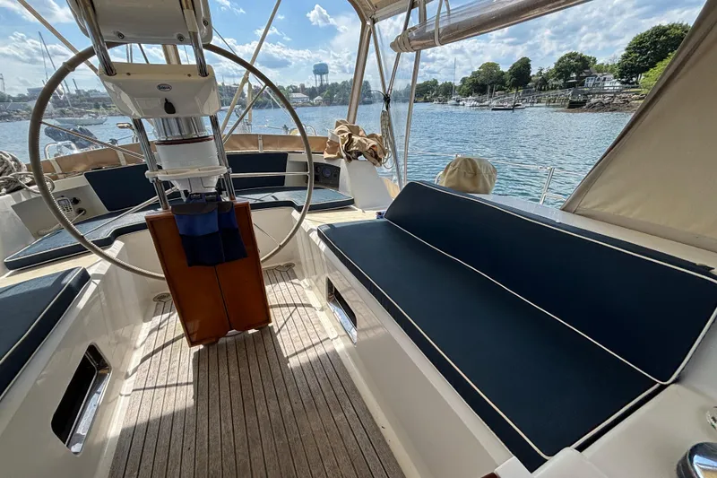 Slide: The Image of Interior view of 2002 Passport 470 Center Cockpit sailboat with blue seating and steering wheel. - 21