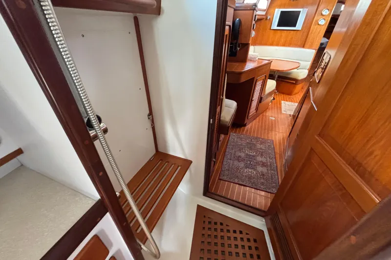 Slide: The Image of Interior of 2002 Passport 470 Center Cockpit yacht, featuring wood finishes and seating area. - 71
