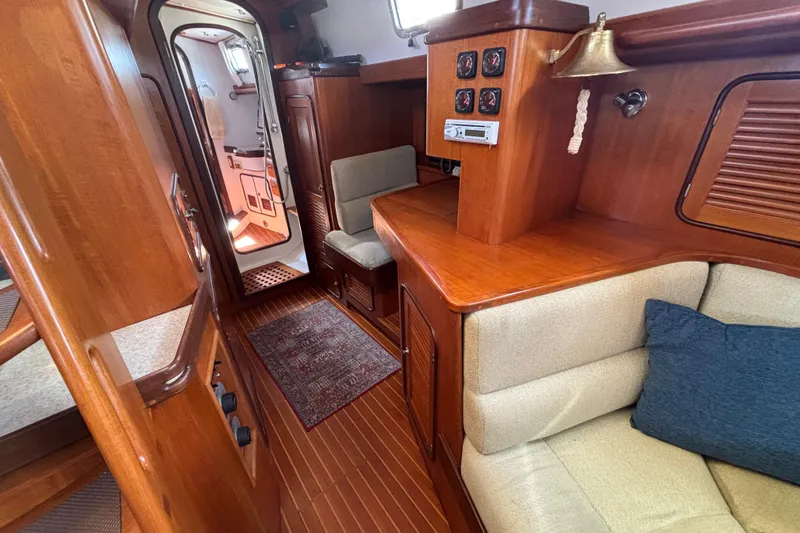 Slide: The Image of Interior of 2002 Passport 470 Center Cockpit yacht with wood finish and cozy seating. - 46