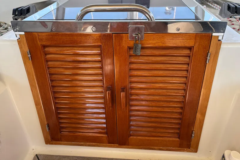 Slide: The Image of Wooden louvered doors with padlock on 2002 Passport 470 Center Cockpit yacht. - 29