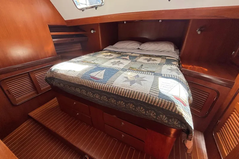 Slide: The Image of Cozy cabin interior of 2002 Passport 470 Center Cockpit with nautical-themed bedding. - 63
