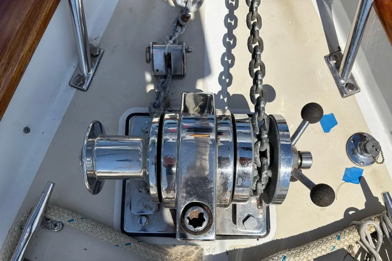 Slide: The Image of Anchor windlass on a 2002 Passport 470 Center Cockpit sailboat deck. - 32