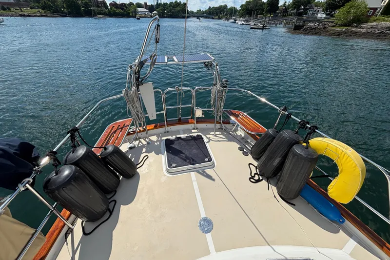 Slide: The Image of Sailboat deck view of 2002 Passport 470 Center Cockpit on calm water. - 17