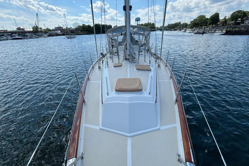 Slide: The Image of Sailboat deck view of 2002 Passport 470 Center Cockpit on calm water. - 14