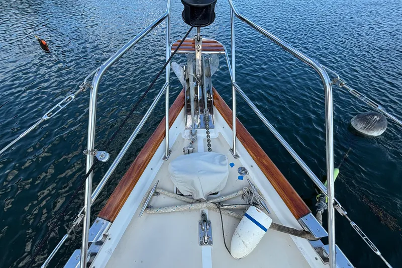 Slide: The Image of Bow view of 2002 Passport 470 Center Cockpit sailboat on calm water. - 30