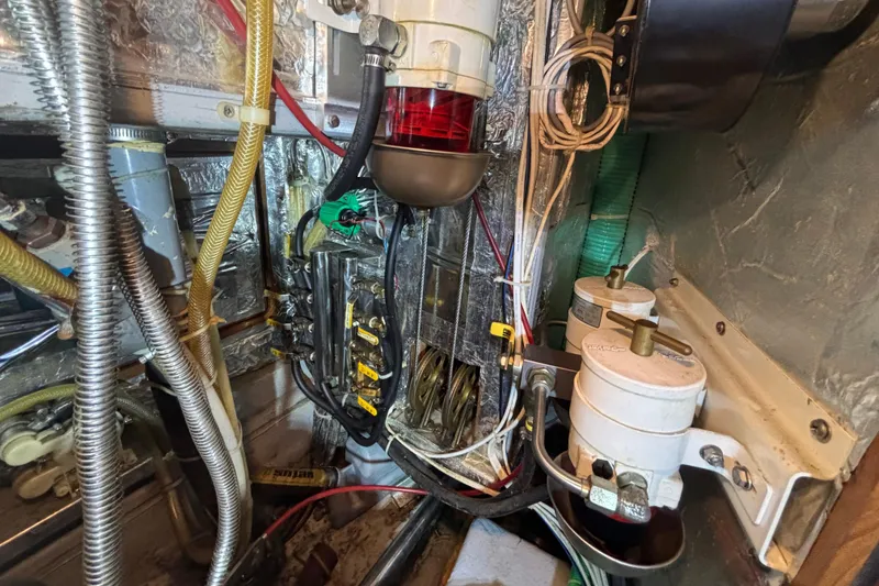 Slide: The Image of Engine room wiring and components of a 2002 Passport 470 Center Cockpit sailboat. - 80