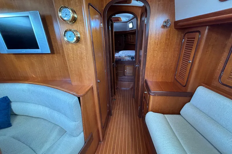 Slide: The Image of Luxurious interior of 2002 Passport 470 Center Cockpit yacht with wood finish and seating. - 54