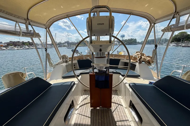 Slide: The Image of Center cockpit of 2002 Passport 470 sailboat with scenic marina view. - 18