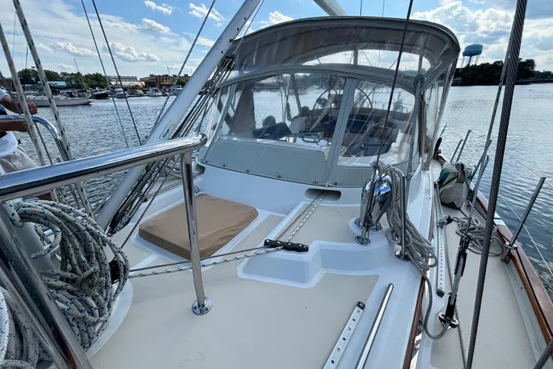 Slide: The Image of 2002 Passport 470 Center Cockpit sailboat docked, showcasing deck and rigging details. - 13