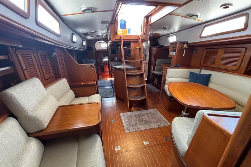 Slide: The Image of Luxurious interior of 2002 Passport 470 Center Cockpit yacht with wooden furnishings and seating. - 38