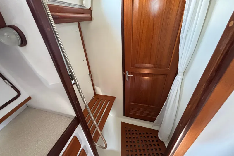 Slide: The Image of Interior of 2002 Passport 470 Center Cockpit yacht with wooden door and shower area. - 70