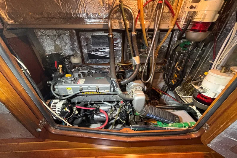 Slide: The Image of Engine compartment of a 2002 Passport 470 Center Cockpit sailboat, showcasing detailed machinery. - 81