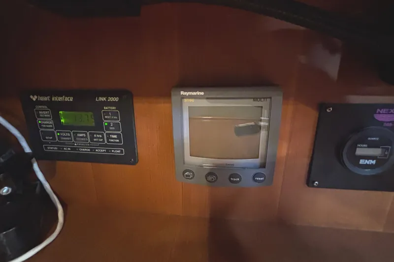Slide: The Image of Control panel of a 2002 Passport 470 Center Cockpit with navigation and battery systems. - 51
