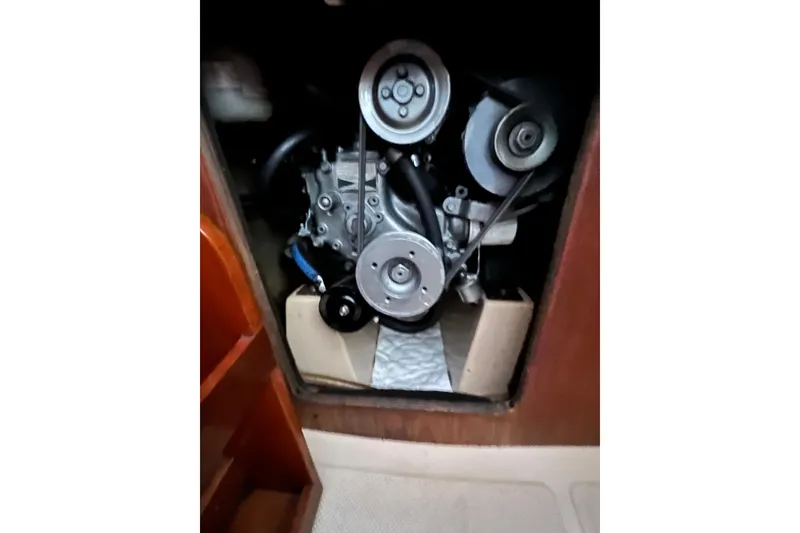 Slide: The Image of Engine compartment of a 1987 Island Packet SP Cruiser sailboat, showcasing mechanical components. - 78