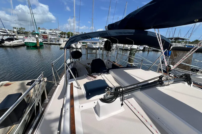 Slide: The Image of 1987 Island Packet SP Cruiser sailboat docked at marina under blue sky. - 8