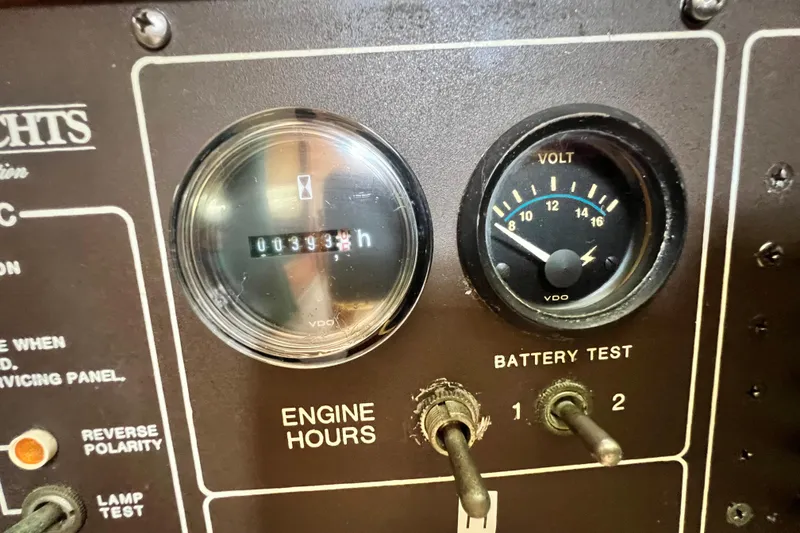 Slide: The Image of Control panel of a 1987 Island Packet SP Cruiser showing engine hours and battery voltage. - 53