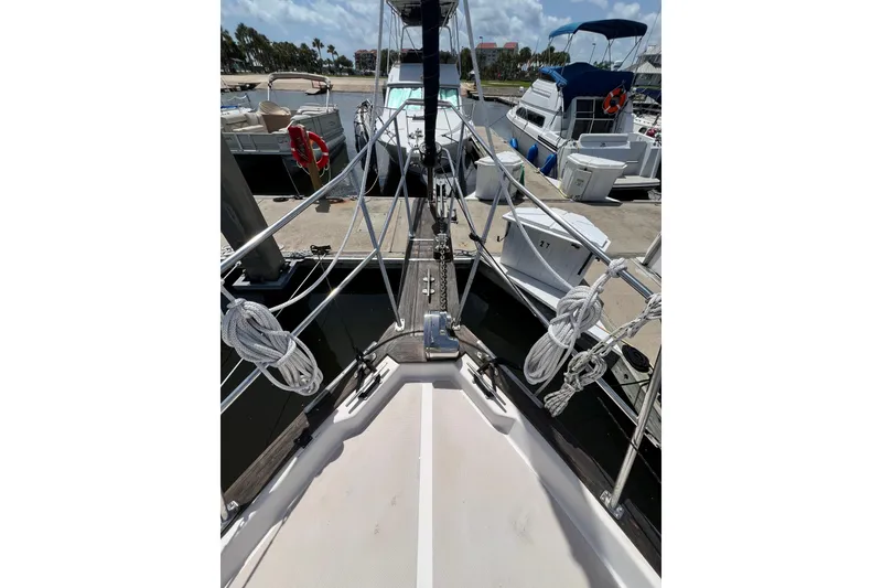 Slide: The Image of Bow view of 1987 Island Packet SP Cruiser docked at marina. - 16