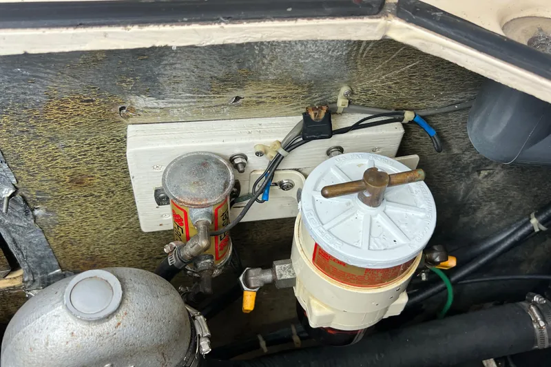 Slide: The Image of Engine compartment of 1987 Island Packet SP Cruiser with fuel filters and wiring. - 85