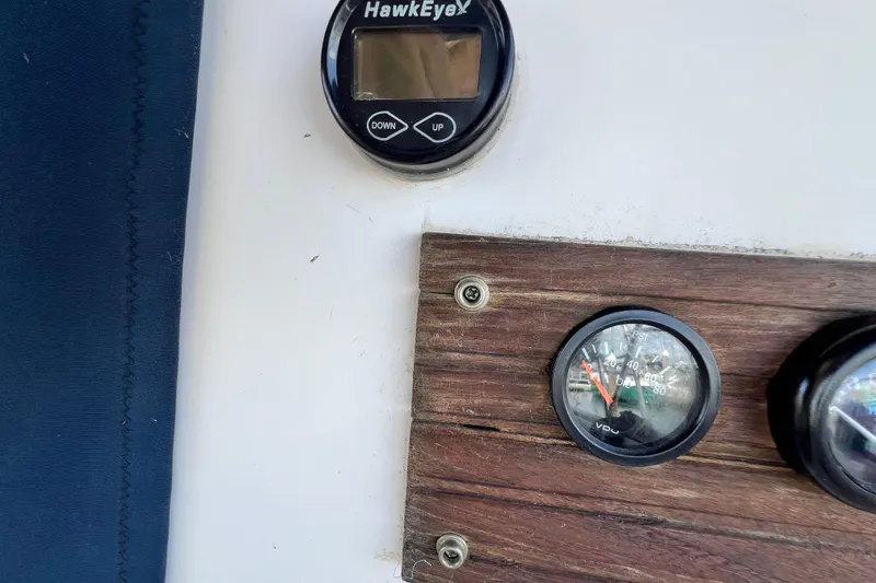 Slide: The Image of Control panel of a 1987 Island Packet SP Cruiser with gauges and a HawkEye display. - 29