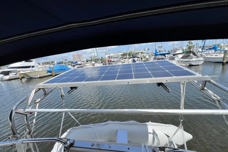 Slide: The Image of 1987 Island Packet SP Cruiser with solar panels docked at marina. - 18