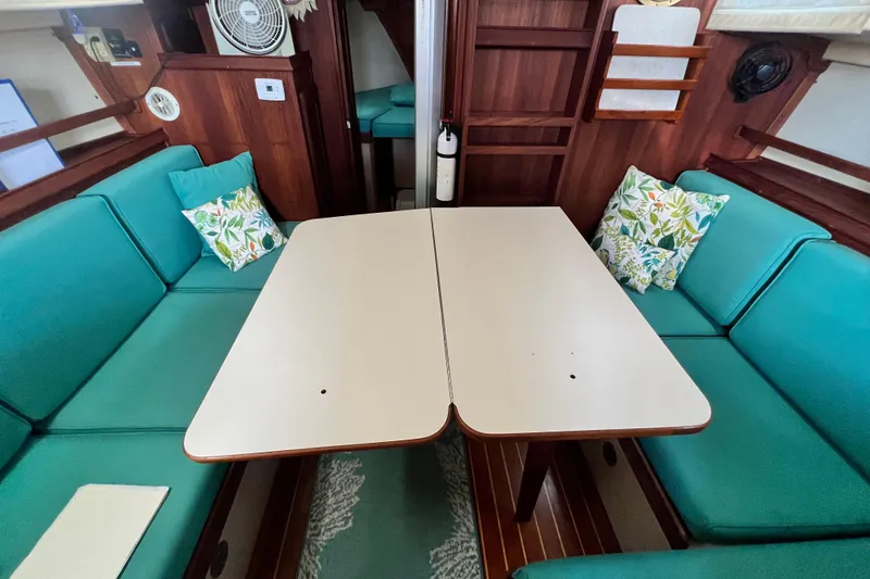 Slide: The Image of Interior of 1987 Island Packet SP Cruiser with teal seating and floral cushions. - 65
