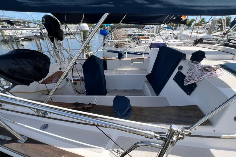 Slide: The Image of 1987 Island Packet SP Cruiser sailboat cockpit with blue covers, docked at marina. - 22