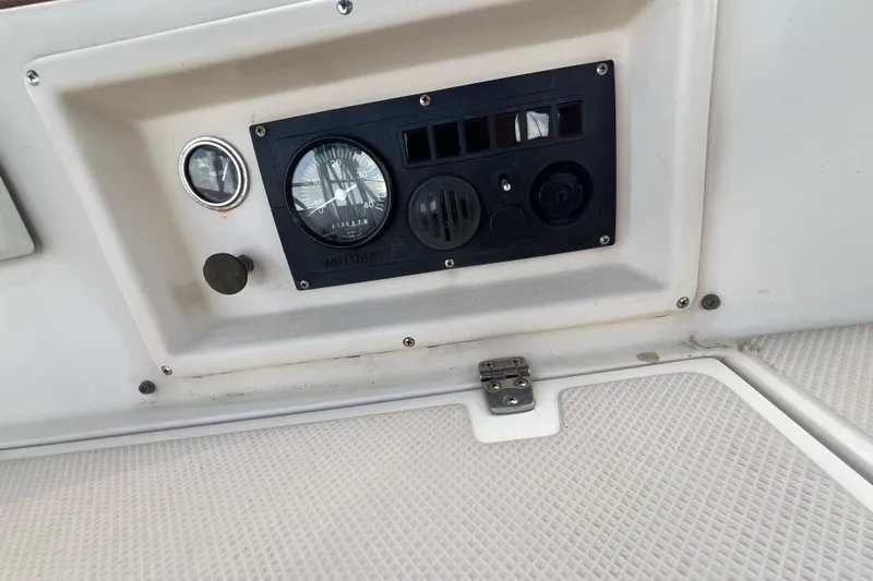 Slide: The Image of Control panel of a 1987 Island Packet SP Cruiser sailboat, featuring gauges and switches. - 27