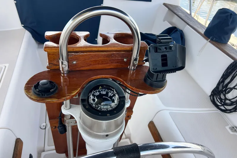 Slide: The Image of Steering console of a 1987 Island Packet SP Cruiser with compass and wooden details. - 39