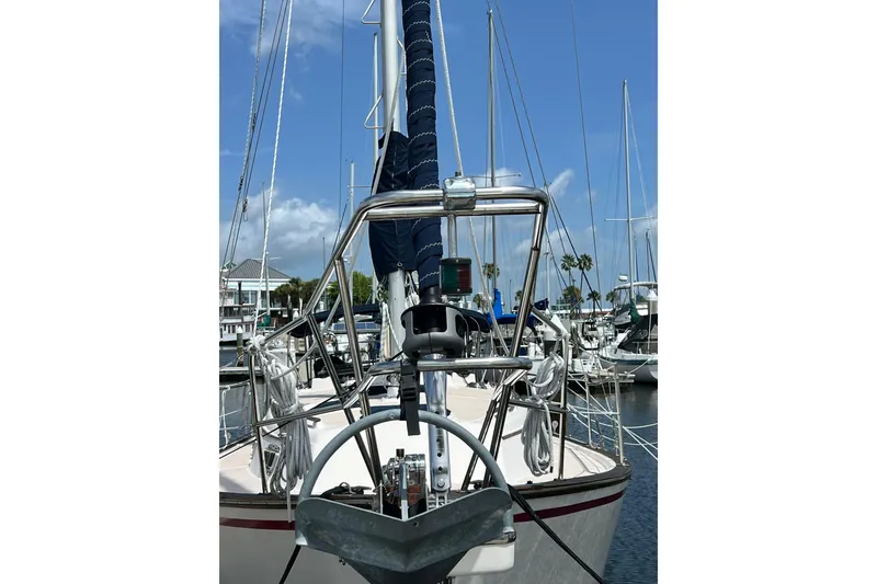 Slide: The Image of 1987 Island Packet SP Cruiser sailboat docked at marina under clear blue sky. - 15