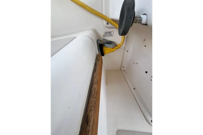 Slide: The Image of 1987 Island Packet SP Cruiser interior with yellow cable and caution label. - 34