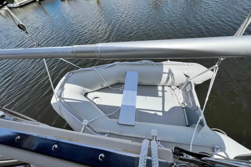 Slide: The Image of Inflatable dinghy on Island Packet SP Cruiser, 1987, docked on calm water. - 21