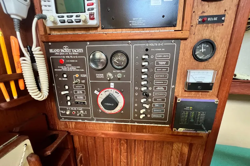 Slide: The Image of Control panel of a 1987 Island Packet SP Cruiser yacht with various switches and gauges. - 50