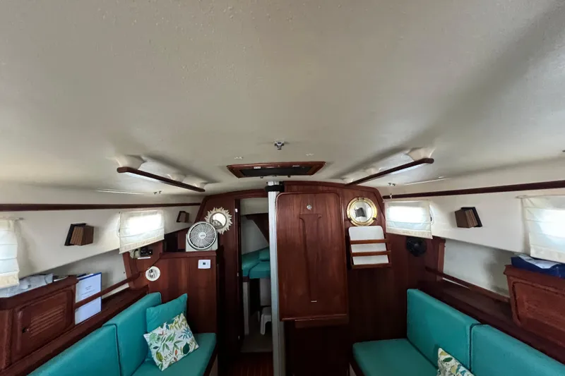 Slide: The Image of Interior of 1987 Island Packet SP Cruiser with teal seating and wooden accents. - 68
