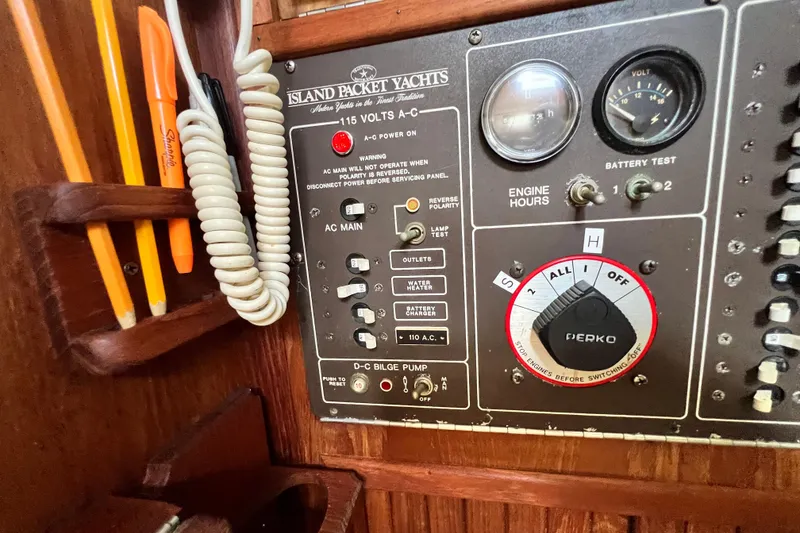 Slide: The Image of Control panel of a 1987 Island Packet SP Cruiser yacht with gauges and switches. - 54