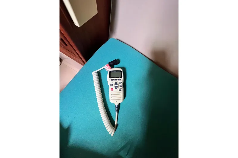 Slide: The Image of Handheld marine radio on a teal surface, Island Packet SP Cruiser 1987. - 48