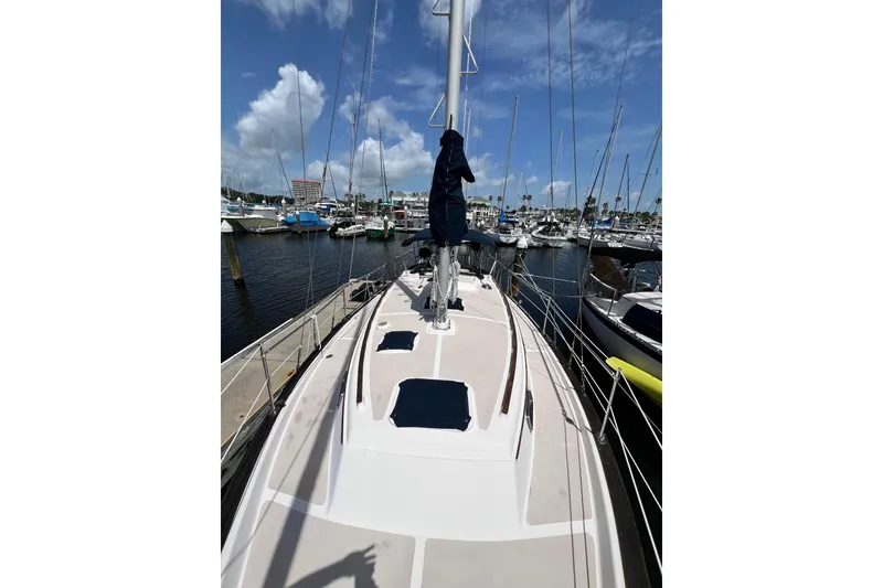 Slide: The Image of 1987 Island Packet SP Cruiser sailboat docked at marina under blue sky. - 10