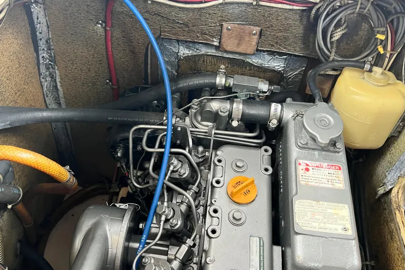 Slide: The Image of Engine compartment of a 1987 Island Packet SP Cruiser, showcasing detailed mechanical components. - 80