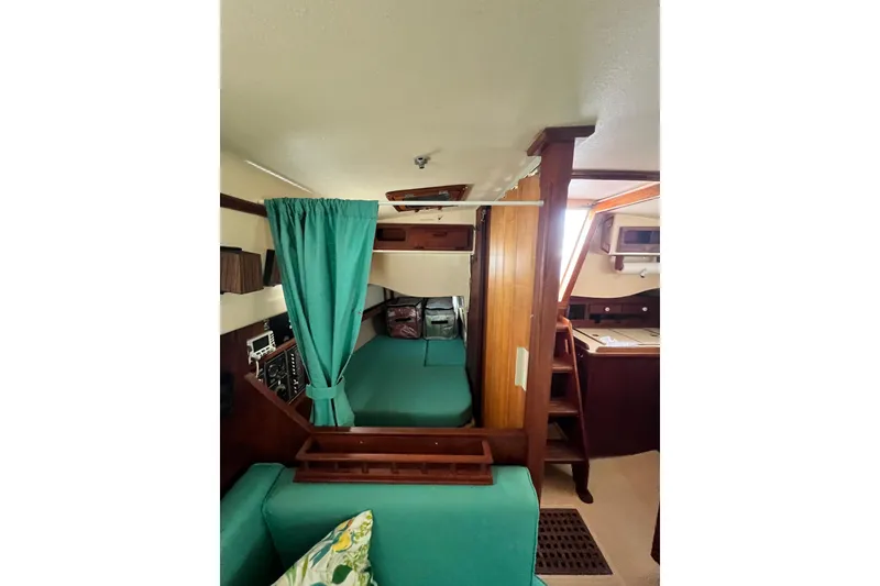 Slide: The Image of Interior of 1987 Island Packet SP Cruiser with green upholstery and wooden accents. - 76