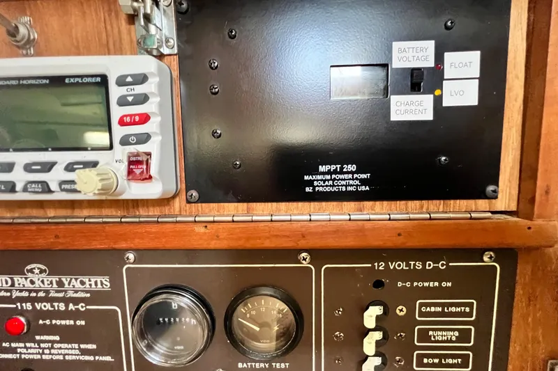 Slide: The Image of Control panel of a 1987 Island Packet SP Cruiser yacht with solar and voltage indicators. - 49