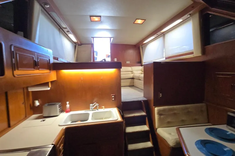 Slide: The Image of Interior of a 1990 Pace 42 yacht featuring a cozy kitchen and seating area. - 50