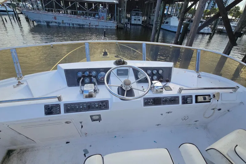 Slide: The Image of Cockpit of a 1990 Pace 42 boat with steering wheel and control panels. - 13