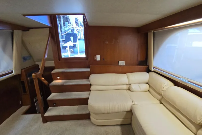 Slide: The Image of Interior of a 1990 Pace 42 yacht with beige sofa and wooden stairs. - 21