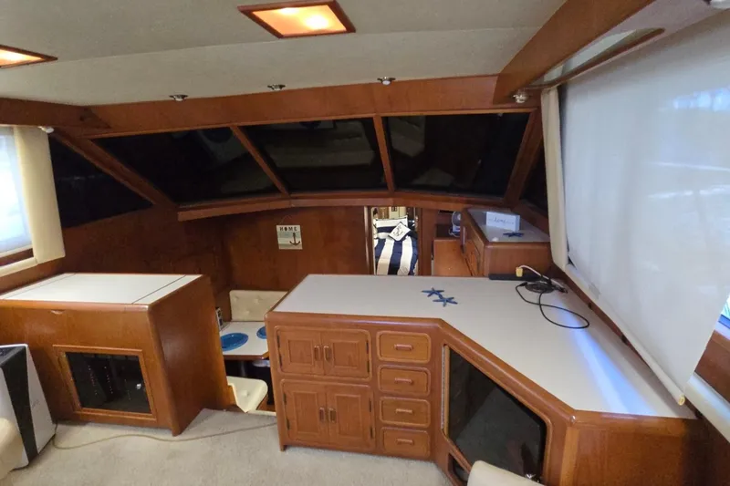 Slide: The Image of Interior of a 1990 Pace 42 yacht with wood cabinetry and large windows. - 23