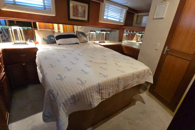 Slide: The Image of Cozy bedroom in 1990 Pace 42 yacht with nautical-themed bedding and wooden accents. - 52