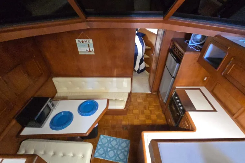 Slide: The Image of Interior of a 1990 Pace 42 boat with kitchen and dining area. - 44