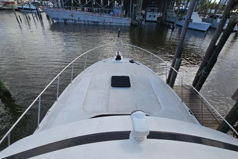 Slide: The Image of Bow view of a 1990 Pace 42 yacht docked at a marina. - 7