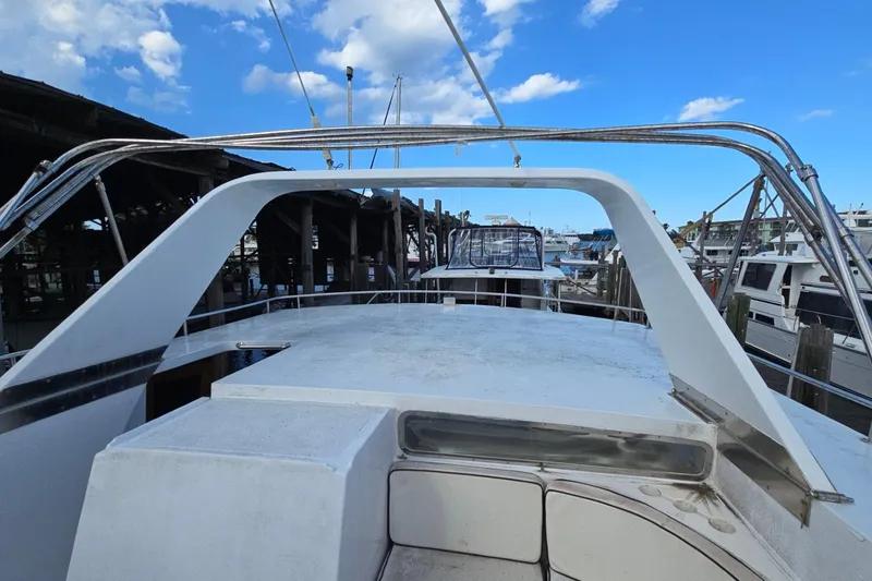 Slide: The Image of 1990 Pace 42 yacht docked at marina under blue sky. - 12